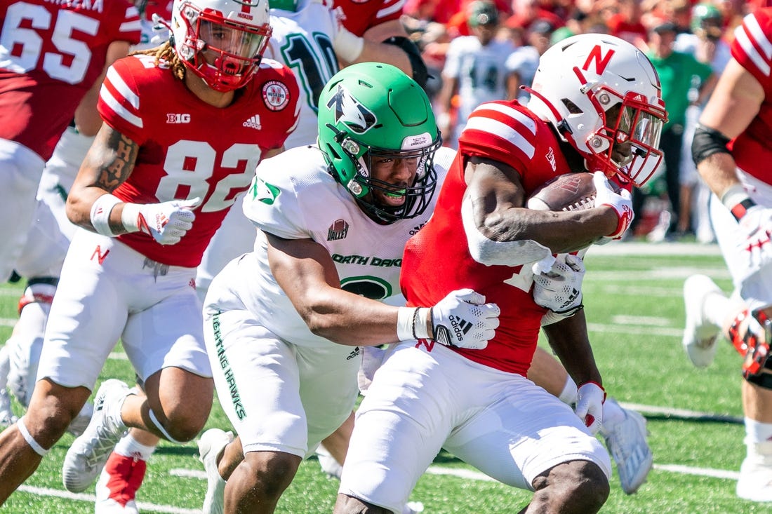 Sep 3, 2022; Lincoln, Nebraska, USA; Nebraska Cornhuskers running back Anthony Grant (10) runs against North Dakota Fighting Hawks linebacker Marcus Vaughn-Jones (9) during the second quarter at Memorial Stadium. Mandatory Credit: Dylan Widger-USA TODAY Sports