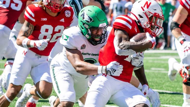 Sep 3, 2022; Lincoln, Nebraska, USA; Nebraska Cornhuskers running back Anthony Grant (10) runs against North Dakota Fighting Hawks linebacker Marcus Vaughn-Jones (9) during the second quarter at Memorial Stadium. Mandatory Credit: Dylan Widger-USA TODAY Sports