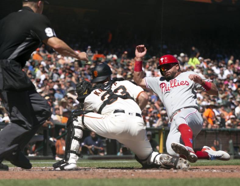 Sep 3, 2022; San Francisco, California, USA; San Francisco Giants catcher Andrew Knapp prepares to put the tag on Philadelphia Phillies left fielder Kyle Schwarber (12) as he attempts to score from third on a ground ball by Alex Bohm during the fifth inning at Oracle Park. Umpire is Chris Segal. Mandatory Credit: D. Ross Cameron-USA TODAY Sports