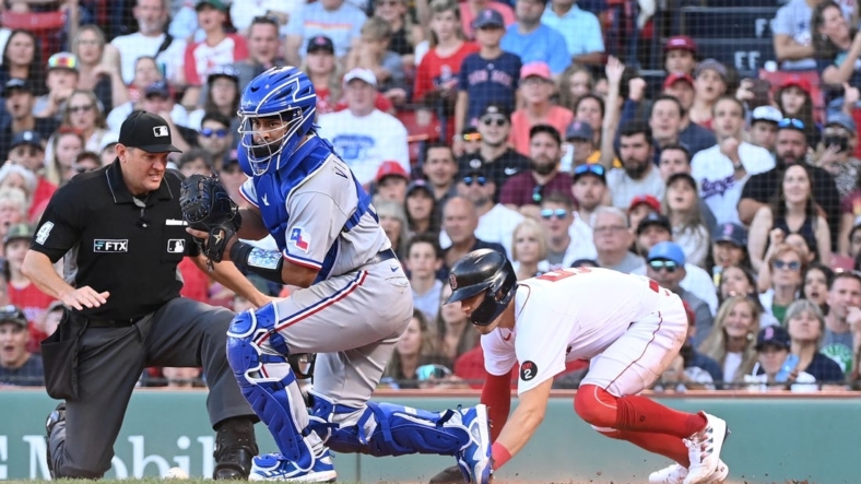 Sep 3, 2022; Boston, Massachusetts, USA; Boston Red Sox center fielder Enrique Hernandez (5) beats Texas Rangers catcher Meibrys Viloria (20) at the plate to score at Fenway Park. Mandatory Credit: Eric Canha-USA TODAY Sports