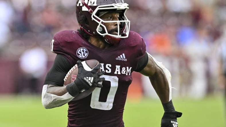 Sep 3, 2022; College Station, Texas, USA;  Texas A&M Aggies wide receiver Ainias Smith (0) runs the ball in for a touchdown during the third quarter against the Sam Houston State Bearkats at Kyle Field. Mandatory Credit: Maria Lysaker-USA TODAY Sports