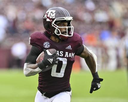 Sep 3, 2022; College Station, Texas, USA;  Texas A&M Aggies wide receiver Ainias Smith (0) runs the ball in for a touchdown during the third quarter against the Sam Houston State Bearkats at Kyle Field. Mandatory Credit: Maria Lysaker-USA TODAY Sports