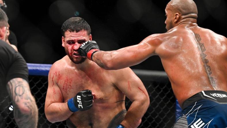 Sep 3, 2022; Paris, FRANCE; Ciryl Gane (red gloves) and Tai Tuivasa (blue gloves) during UFC Fight Night at Accor Arena. Mandatory Credit: Per Haljestam-USA TODAY Sports