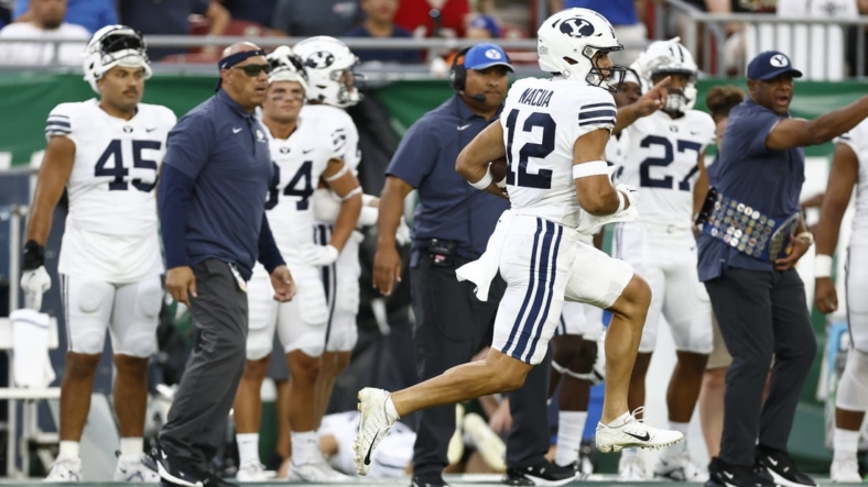 Sep 3, 2022; Tampa, Florida, USA; Brigham Young Cougars wide receiver Puka Nacua (12) runs the ball in for a touchdown against the South Florida Bulls during the first half at Raymond James Stadium. Mandatory Credit: Douglas DeFelice-USA TODAY Sports