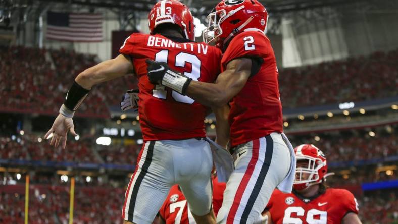 Sep 3, 2022; Atlanta, Georgia, USA; Georgia Bulldogs quarterback Stetson Bennett (13) celebrates with running back Kendall Milton (2) after a touchdown run against the Oregon Ducks in the second quarter at Mercedes-Benz Stadium. Mandatory Credit: Brett Davis-USA TODAY Sports