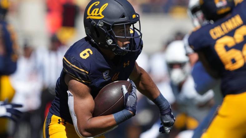 Sep 3, 2022; Berkeley, California, USA; California Golden Bears running back Jaydn Ott (6) carries the ball against the UC Davis Aggies during the third quarter at FTX Field at California Memorial Stadium. Mandatory Credit: Darren Yamashita-USA TODAY Sports