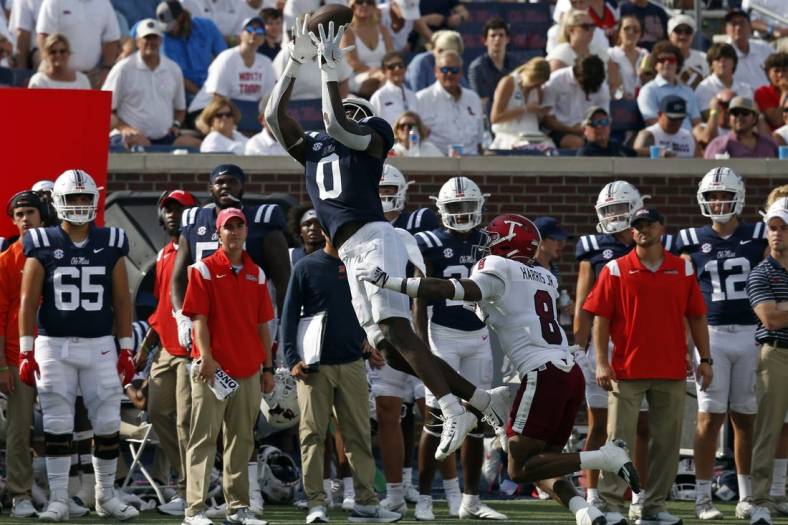Sep 3, 2022; Oxford, Mississippi, USA; Mississippi Rebels tight end Michael Trigg (0) catches the ball against Troy Trojans defensive back TJ Harris (8) during the second half at Vaught-Hemingway Stadium. Mandatory Credit: Petre Thomas-USA TODAY Sports