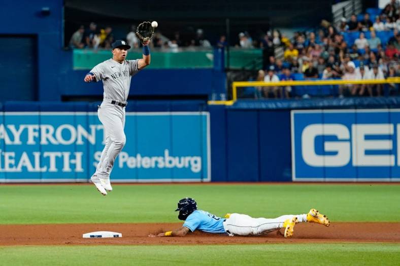 Sep 3, 2022; St. Petersburg, Florida, USA; New York Yankees shortstop Oswald Peraza (91) catches a throw as Tampa Bay Rays center fielder Jose Siri (22) slides in to second during the fifth inning  at Tropicana Field. Mandatory Credit: Rich Storry-USA TODAY Sports