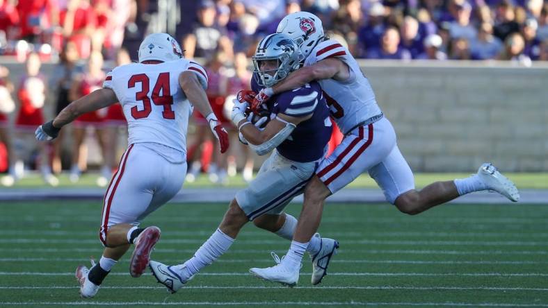 Sep 3, 2022; Manhattan, Kansas, USA; Kansas State Wildcats tight end Ben Sinnott (34) is tackled by South Dakota Coyotes linebacker Stephen Hillis (34) and South Dakota Coyotes linebacker Gage Tennyson (38) during the first quarter at Bill Snyder Family Football Stadium. Mandatory Credit: Scott Sewell-USA TODAY Sports