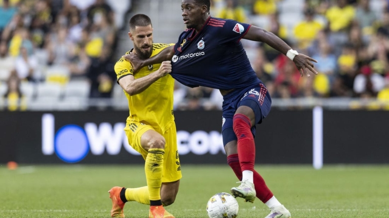 Sep 3, 2022; Columbus, Ohio, USA; Columbus Crew defender Milos Degenek (5) tries to pull Chicago Fire forward Jhon Duran (26) off the ball in the second half at Lower.com Field. Mandatory Credit: Greg Bartram-USA TODAY Sports