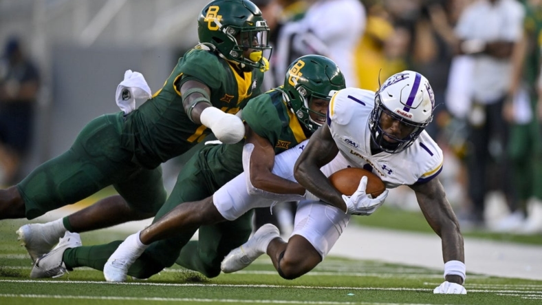 Sep 3, 2022; Waco, Texas, USA; Albany Great Danes wide receiver Julian Hicks (1) is tackled by Baylor Bears safety Al Walcott (13) during the second quarter at McLane Stadium. Mandatory Credit: Jerome Miron-USA TODAY Sports
