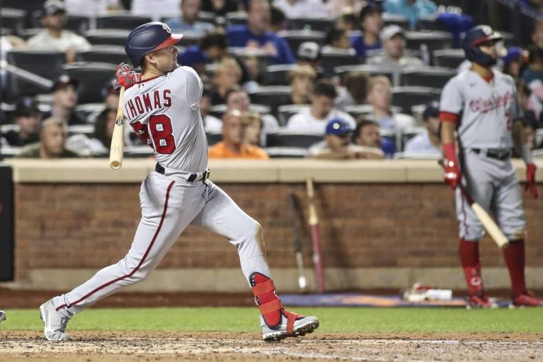 Sep 3, 2022; New York City, New York, USA; Washington Nationals center fielder Lane Thomas (28) hits a solo home run in the eighth inning against the New York Mets at Citi Field. Mandatory Credit: Wendell Cruz-USA TODAY Sports