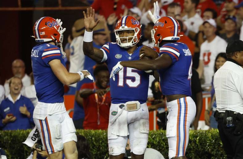 Sep 3, 2022; Gainesville, Florida, USA; Florida Gators quarterback Anthony Richardson (15) is congratulated  by wide receiver Justin Shorter (4) and wide receiver Ricky Pearsall (1) as he scored a touchdown during the second quarter at Steve Spurrier-Florida Field. Mandatory Credit: Kim Klement-USA TODAY Sports