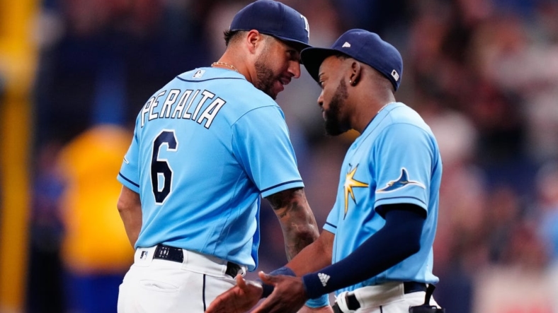 Sep 3, 2022; St. Petersburg, Florida, USA; Tampa Bay Rays left fielder David Peralta (6) and second baseman Vidal Brujan (7) celebrate after winning against the New York Yankees at Tropicana Field. Mandatory Credit: Rich Storry-USA TODAY Sports