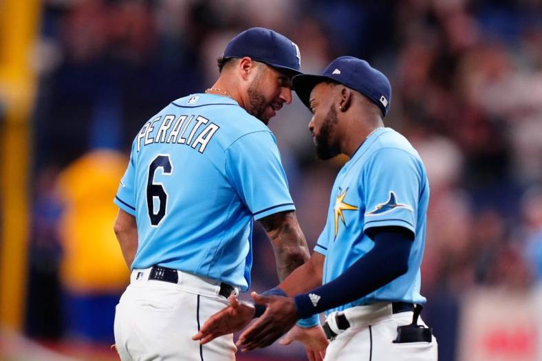 Sep 3, 2022; St. Petersburg, Florida, USA; Tampa Bay Rays left fielder David Peralta (6) and second baseman Vidal Brujan (7) celebrate after winning against the New York Yankees at Tropicana Field. Mandatory Credit: Rich Storry-USA TODAY Sports