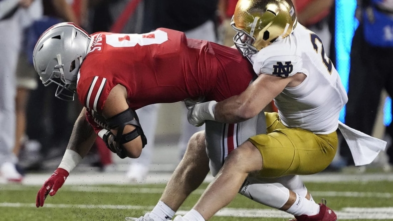 Sep 3, 2022; Columbus, Ohio, USA; Ohio State Buckeyes tight end Cade Stover (8) gets tackled by Notre Dame Fighting Irish linebacker JD Bertrand (27) after a catch in the second quarter of the NCAA football game between Ohio State Buckeyes and Notre Dame Fighting Irish at Ohio Stadium. Mandatory Credit: Kyle Robertson-USA TODAY Sports