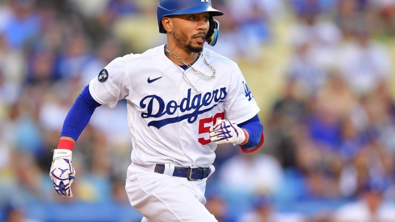 Sep 3, 2022; Los Angeles, California, USA; Los Angeles Dodgers second baseman Mookie Betts (50) runs after hitting a triple against the San Diego Padres during the first inning  at Dodger Stadium. Mandatory Credit: Gary A. Vasquez-USA TODAY Sports