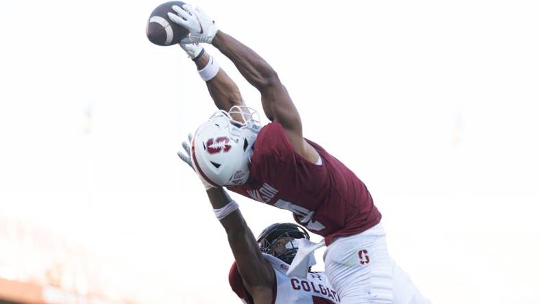 Sep 3, 2022; Stanford, California, USA;  Stanford Cardinal wide receiver Michael Wilson (4) catches the ball for a touchdown over Colgate Raiders defensive back Asauni Allen (7) during the second quarter at Stanford Stadium. Mandatory Credit: Stan Szeto-USA TODAY Sports