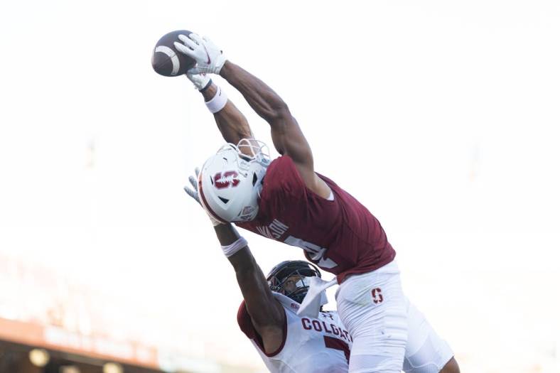 Sep 3, 2022; Stanford, California, USA;  Stanford Cardinal wide receiver Michael Wilson (4) catches the ball for a touchdown over Colgate Raiders defensive back Asauni Allen (7) during the second quarter at Stanford Stadium. Mandatory Credit: Stan Szeto-USA TODAY Sports