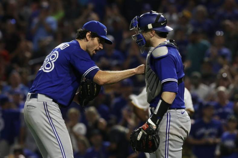 Sep 3, 2022; Pittsburgh, Pennsylvania, USA;  Toronto Blue Jays relief pitcher Jordan Romano (68) and catcher Danny Jansen (9) celebrate after defeating the Pittsburgh Pirates at PNC Park. Toronto won 4-1. Mandatory Credit: Charles LeClaire-USA TODAY Sports