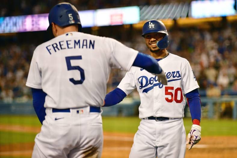 Sep 3, 2022; Los Angeles, California, USA; Los Angeles Dodgers second baseman Mookie Betts (50) is greeted by first baseman Freddie Freeman (5) after hitting a three run home run against the San Diego Padres during the fourth inning at Dodger Stadium. Mandatory Credit: Gary A. Vasquez-USA TODAY Sports