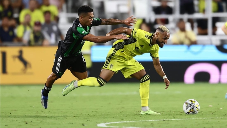Sep 3, 2022; Nashville, Tennessee, USA;  Nashville SC midfielder Hany Mukhtar (10) gets pushed by Austin FC midfielder Daniel Pereira (6) in the first half at Geodis Park. Mandatory Credit: Casey Gower-USA TODAY Sports