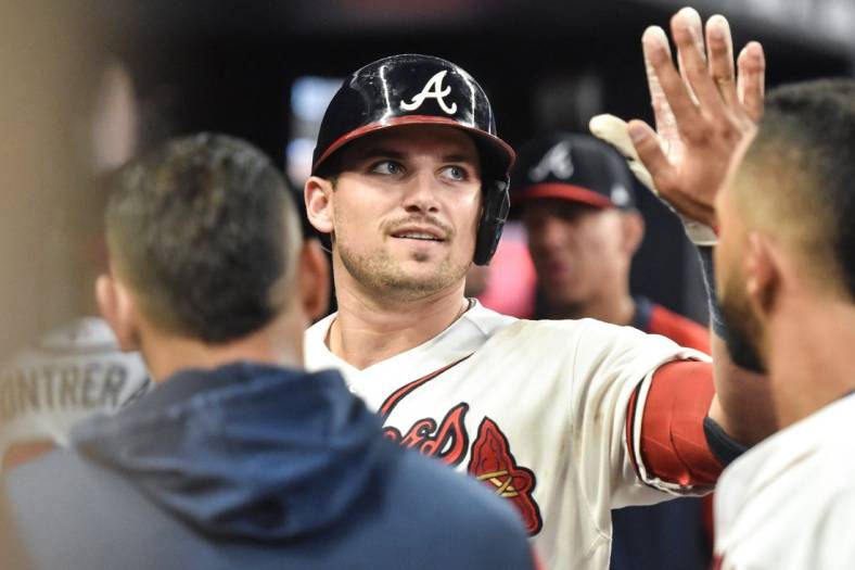 Sep 3, 2022; Cumberland, Georgia, USA; Atlanta Braves third baseman Austin Riley (27) celebrates with teammates after hitting a home run against the Miami Marlins in the fourth inning at Truist Park. Mandatory Credit: Larry Robinson-USA TODAY Sports