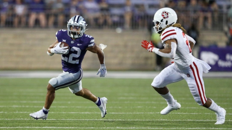 Sep 3, 2022; Manhattan, Kansas, USA; Kansas State Wildcats running back Deuce Vaughn (22) is chased by South Dakota Coyotes linebacker Tre Thomas (21) during the second quarter at Bill Snyder Family Football Stadium. Mandatory Credit: Scott Sewell-USA TODAY Sports