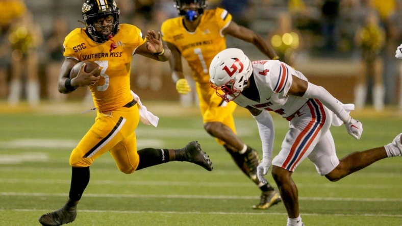 Sep 3, 2022; Hattiesburg, Mississippi, USA; Southern Miss Golden Eagles running back Frank Gore Jr. (3) runs from Liberty Flames cornerback Chris Megginson (4) in the second half at M.M. Roberts Stadium. Liberty won in overtime, 29-27. Mandatory Credit: Chuck Cook-USA TODAY Sports
