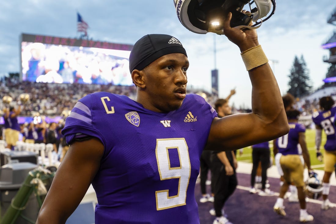 Sep 3, 2022; Seattle, Washington, USA; Washington Huskies quarterback Michael Penix Jr. (9) raises his helmet before kickoff against the Kent State Golden Flashes at Alaska Airlines Field at Husky Stadium. Mandatory Credit: Joe Nicholson-USA TODAY Sports