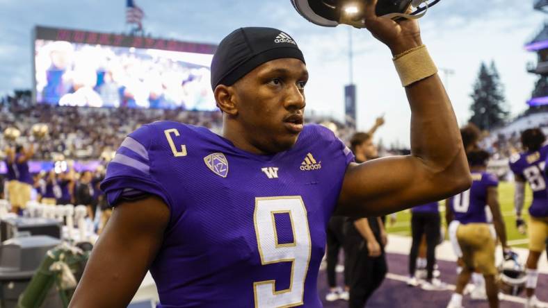 Sep 3, 2022; Seattle, Washington, USA; Washington Huskies quarterback Michael Penix Jr. (9) raises his helmet before kickoff against the Kent State Golden Flashes at Alaska Airlines Field at Husky Stadium. Mandatory Credit: Joe Nicholson-USA TODAY Sports