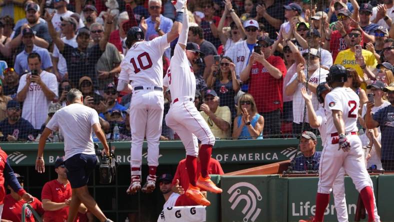 Sep 4, 2022; Boston, Massachusetts, USA; Boston Red Sox center fielder Enrique Hernandez (5) hi fives second baseman Trevor Story (10) for hitting a three-run home run against the Texas Rangers during the first inning at Fenway Park. Mandatory Credit: Gregory Fisher-USA TODAY Sports