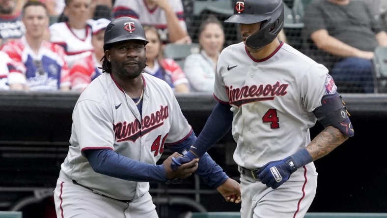 Sep 4, 2022; Chicago, Illinois, USA; Minnesota Twins shortstop Carlos Correa (4) is greeted by third base coach Tommy Watkins (40) after hitting a two-run home run against the Chicago White Sox during the fifth inning at Guaranteed Rate Field. Mandatory Credit: David Banks-USA TODAY Sports