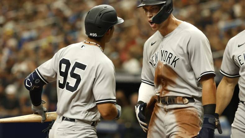 Sep 4, 2022; St. Petersburg, Florida, USA; New York Yankees right fielder Aaron Judge (99) celebrates as he scores a run on shortstop Oswaldo Cabrera (95) sacrifice RBI against the Tampa Bay Rays during the seventh inning  at Tropicana Field. Mandatory Credit: Kim Klement-USA TODAY Sports