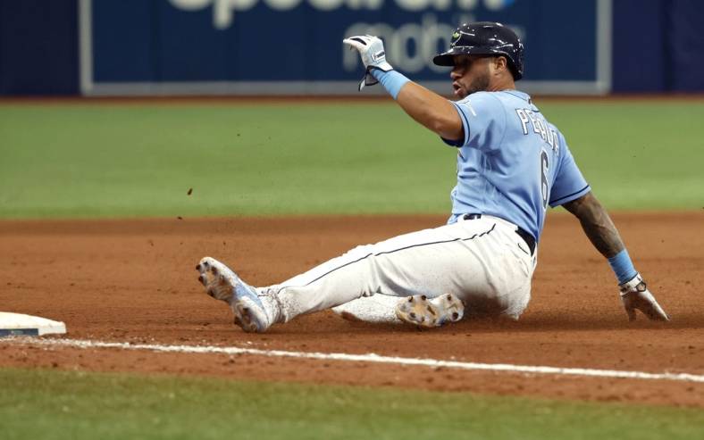 Sep 4, 2022; St. Petersburg, Florida, USA; Tampa Bay Rays left fielder David Peralta (6) slides into third base against the New York Yankees during the ninth inning at Tropicana Field. Mandatory Credit: Kim Klement-USA TODAY Sports