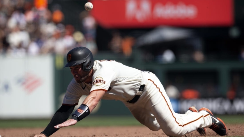Sep 4, 2022; San Francisco, California, USA; San Francisco Giants catcher Austin Wynns tries to go from first to third on an RBI single by Bryce Johnson during the fourth inning against the Philadelphia Phillies at Oracle Park. Wynns was thrown out at third base on the play. Mandatory Credit: D. Ross Cameron-USA TODAY Sports