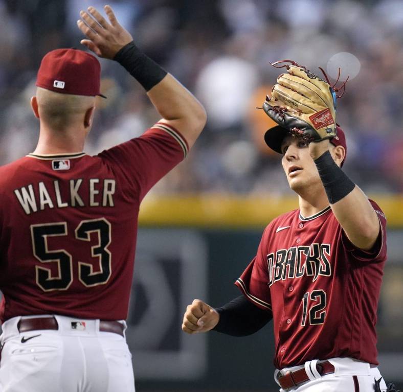 Sep 4, 2022; Phoenix, AZ, USA; Arizona Diamondbacks' Christian Walker (53) high-fives Daulton Varsho (12) after his catch in the outfield against the Milwaukee Brewers at Chase Field. Mandatory Credit: Joe Rondone-Arizona Republic

Mlb Brewers At D Backs