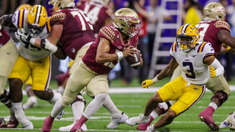 Sep 4, 2022; New Orleans, Louisiana, USA; Florida State Seminoles quarterback Jordan Travis (13) scrambles away from LSU Tigers safety Greg Brooks Jr. (3) during the first half of the game at Caesars Superdome. Mandatory Credit: Stephen Lew-USA TODAY Sports