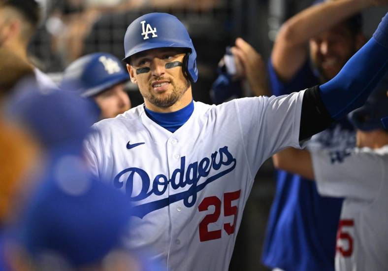 Sep 4, 2022; Los Angeles, California, USA;  Los Angeles Dodgers right fielder Trayce Thompson (25) is congratulated in the dugout after hitting a pinch hit three run home run in the seventh inning against the San Diego Padres at Dodger Stadium. Mandatory Credit: Jayne Kamin-Oncea-USA TODAY Sports