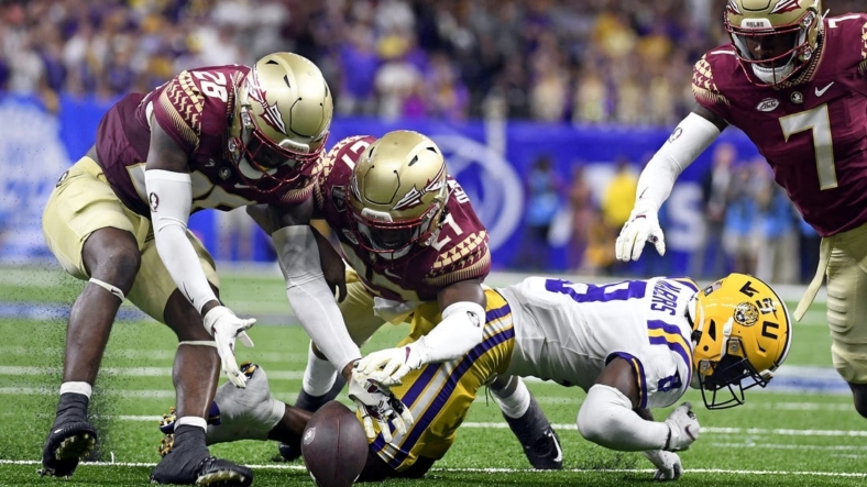 Sep 4, 2022; New Orleans, Louisiana, USA; Louisiana State Tigers wide receiver Malik Nabers (8) fumbles a punt return that is recovered by Florida State Seminoles linebacker Brendan Gant (28) during the second half at Caesars Superdome. Mandatory Credit: Melina Myers-USA TODAY Sports