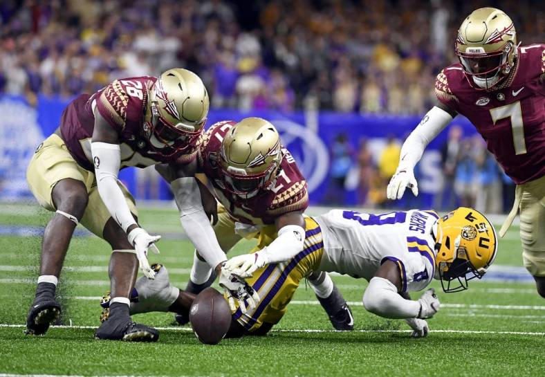 Sep 4, 2022; New Orleans, Louisiana, USA; Louisiana State Tigers wide receiver Malik Nabers (8) fumbles a punt return that is recovered by Florida State Seminoles linebacker Brendan Gant (28) during the second half at Caesars Superdome. Mandatory Credit: Melina Myers-USA TODAY Sports