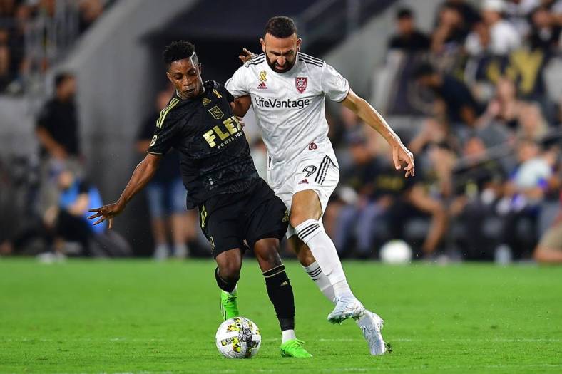 Sep 4, 2022; Los Angeles, California, USA; Los Angeles FC forward Latif Blessing (7) plays for the ball against Real Salt Lake forward Justin Meram (9) during the second half at Banc of California Stadium. Mandatory Credit: Gary A. Vasquez-USA TODAY Sports