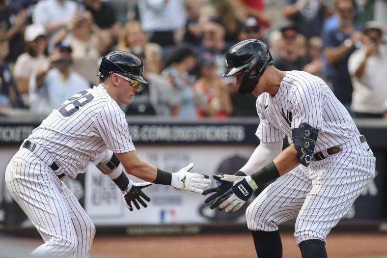 Sep 5, 2022; Bronx, New York, USA;  New York Yankees center fielder Aaron Judge (99) is greeted by New York Yankees third baseman Josh Donaldson (28) after hitting a two run home run in the sixth inning against the Minnesota Twins at Yankee Stadium. Mandatory Credit: Wendell Cruz-USA TODAY Sports
