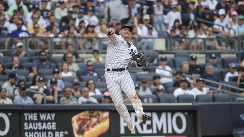 Sep 5, 2022; Bronx, New York, USA;  New York Yankees third baseman Josh Donaldson (28) makes a leaping throw to complete an inning ending double play in the seventh inning against the Minnesota Twins at Yankee Stadium. Mandatory Credit: Wendell Cruz-USA TODAY Sports