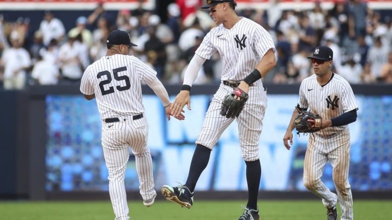 Sep 5, 2022; Bronx, New York, USA;  New York Yankees second baseman Gleyber Torres (25) and right fielder Aaron Judge (99) celebrate after defeating the Minnesota Twins 5-2 at Yankee Stadium. Mandatory Credit: Wendell Cruz-USA TODAY Sports