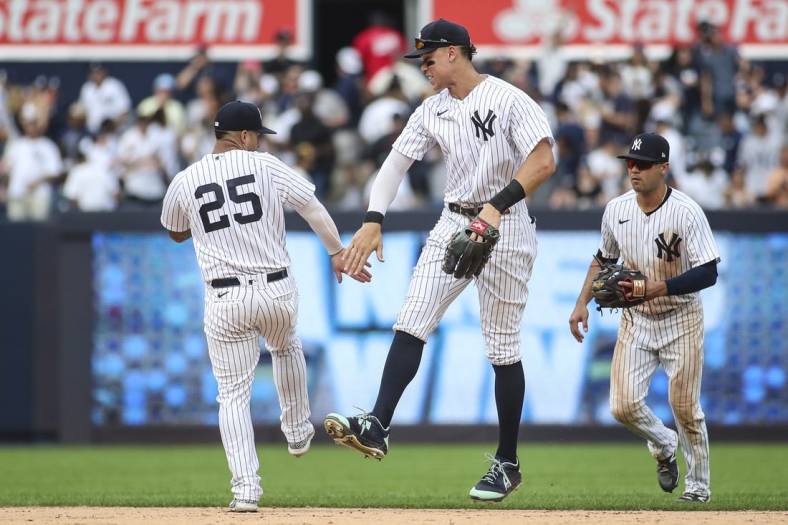 Sep 5, 2022; Bronx, New York, USA;  New York Yankees second baseman Gleyber Torres (25) and right fielder Aaron Judge (99) celebrate after defeating the Minnesota Twins 5-2 at Yankee Stadium. Mandatory Credit: Wendell Cruz-USA TODAY Sports