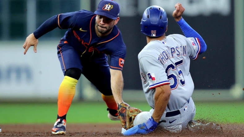 Sep 5, 2022; Houston, Texas, USA; Houston Astros second baseman Jose Altuve (27) tags out Texas Rangers left fielder Bubby Thompson (65) on a stolen base attempt during the third inning at Minute Maid Park. Mandatory Credit: Erik Williams-USA TODAY Sports