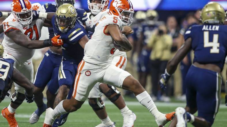 Sep 5, 2022; Atlanta, Georgia, USA; Clemson Tigers quarterback DJ Uiagalelei (5) runs the ball against the Georgia Tech Yellow Jackets in the second quarter at Mercedes-Benz Stadium. Mandatory Credit: Brett Davis-USA TODAY Sports