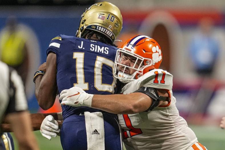 Sep 5, 2022; Atlanta, Georgia, USA; Clemson Tigers defensive tackle Bryan Bresee (11) tackles Georgia Tech Yellow Jackets quarterback Jeff Sims (10) for a loss during the second half at Mercedes-Benz Stadium. Mandatory Credit: Dale Zanine-USA TODAY Sports