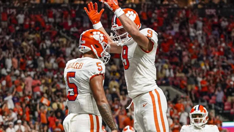 Sep 5, 2022; Atlanta, Georgia, USA; Clemson Tigers quarterback DJ Uiagalelei (5) reacts with tight end Jake Briningstool (9) after running for a touchdown against the Georgia Tech Yellow Jackets during the second half at Mercedes-Benz Stadium. Mandatory Credit: Dale Zanine-USA TODAY Sports